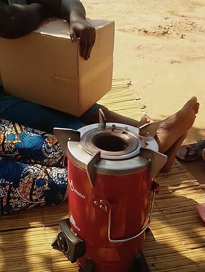 Queen with her cookstove
(credit: Sagaci Research)